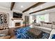 Comfortable living room with wooden beams, fireplace, hardwood floors, and stylish furnishings at 4237 Rowan St, Raleigh, NC 27609