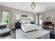 Serene main bedroom with tray ceilings, hardwood floors, large windows, and a sitting area at 4237 Rowan St, Raleigh, NC 27609