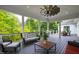 Covered porch with outdoor seating, ceiling fan, and grill, perfect for relaxing and entertaining guests at 4237 Rowan St, Raleigh, NC 27609