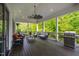 Spacious covered porch with comfortable seating, a ceiling fan, and an outdoor grill, ideal for gatherings at 4237 Rowan St, Raleigh, NC 27609