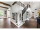 Open staircase with dark wood handrails and carpeted steps leading to the second floor at 4237 Rowan St, Raleigh, NC 27609