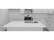 Kitchen island with stainless steel sink, modern faucet, white cabinets and stainless oven at 433 Providence Springs Ln, Fuquay Varina, NC 27526