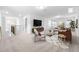 Open living room with plush carpet, modern furniture, and great natural lighting offers a welcoming space at 433 Providence Springs Ln, Fuquay Varina, NC 27526