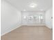Bright, empty living room with wood flooring, white walls, and natural light streaming through the windows at 433 Providence Springs Ln, Fuquay Varina, NC 27526