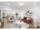 Inviting living room with a cozy sofa, stylish rug, and an open-concept layout at 433 Providence Springs Ln, Fuquay Varina, NC 27526