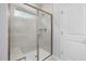 This modern shower features stylish tile, a glass door, and a convenient built-in bench at 433 Providence Springs Ln, Fuquay Varina, NC 27526