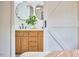 Bathroom boasts double sinks, contemporary fixtures, and stylish mirrors viewed through a sliding barn door at 4513 Denfield St, Durham, NC 27704