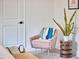 Bedroom with decorative chair, plant, and side table complementing the comfortable, inviting atmosphere at 4513 Denfield St, Durham, NC 27704