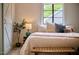 Cozy bedroom boasting natural light, neutral tones, and comfortable inviting finishes at 4513 Denfield St, Durham, NC 27704