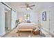 Bright bedroom featuring a ceiling fan, barn door closet, and a comfortable inviting bed at 4513 Denfield St, Durham, NC 27704