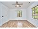 Bright bedroom featuring natural light, ceiling fan, and stylish hardwood floors at 4513 Denfield St, Durham, NC 27704