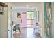 Light-filled entryway with a charming pink front door and stylish decor at 4513 Denfield St, Durham, NC 27704