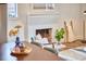 Close up of the fireplace with painted brick and decor in a sunlit living room at 4513 Denfield St, Durham, NC 27704