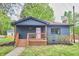 Charming single-story home with inviting porch and delightful pink front door at 4513 Denfield St, Durham, NC 27704