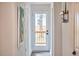 Hallway leading to back door with coat rack and artwork at 4513 Denfield St, Durham, NC 27704