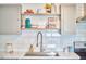 Bright kitchen displaying white backsplash and marble countertops complemented by a stainless steel faucet at 4513 Denfield St, Durham, NC 27704