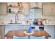 Cozy kitchen view highlighting the stainless steel appliances, marble countertops, and dining area at 4513 Denfield St, Durham, NC 27704