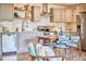 Spacious kitchen featuring grey cabinets, stainless steel appliances, and a dining area with seating at 4513 Denfield St, Durham, NC 27704