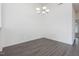 Empty dining room with new floors and a contemporary light fixture at 522 Auburn Square Dr, Durham, NC 27713
