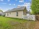 Landscaped backyard featuring a white fence and exterior of the home at 522 Auburn Square Dr, Durham, NC 27713