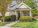 Charming home with a covered front porch, tidy landscaping, and neutral siding at 522 Auburn Square Dr, Durham, NC 27713
