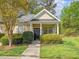 Inviting single-story home featuring a quaint front porch and well-maintained landscaping at 522 Auburn Square Dr, Durham, NC 27713