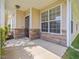 Covered front porch featuring stone accents and neutral toned siding at 522 Auburn Square Dr, Durham, NC 27713