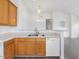 An open kitchen with stainless sink, dishwasher and white appliances at 522 Auburn Square Dr, Durham, NC 27713