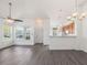 Open living area features hardwood floors, large windows, and a view into the kitchen at 522 Auburn Square Dr, Durham, NC 27713