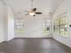 Spacious living room with large windows, a ceiling fan, and modern floors at 522 Auburn Square Dr, Durham, NC 27713