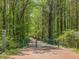 Scenic shot of a paved trail in a community surrounded by lush, green forest at 522 Auburn Square Dr, Durham, NC 27713