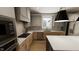 This contemporary kitchen features a tile backsplash, stainless appliances, and hardwood floors at 524 Folk Song Way, Wendell, NC 27591