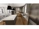 Modern kitchen featuring stainless steel appliances, gray cabinets, quartz countertops and hardwood floors at 524 Folk Song Way, Wendell, NC 27591