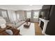 Spacious living room featuring a decorative fireplace, large windows and hardwood flooring at 524 Folk Song Way, Wendell, NC 27591