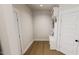 Mud room with white walls, hardwood floors, white bench and storage at 524 Folk Song Way, Wendell, NC 27591