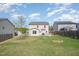 Large backyard with a patio, fire pit, and a lush green lawn, perfect for relaxation and entertainment at 528 Holden Forest Dr, Youngsville, NC 27596