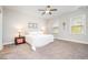 Bright bedroom with plush carpet, a ceiling fan, and windows providing natural light at 528 Holden Forest Dr, Youngsville, NC 27596