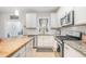 Modern kitchen featuring stainless steel appliances, granite countertops, white cabinets, and wood floors at 528 Holden Forest Dr, Youngsville, NC 27596