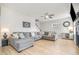 Inviting living room with a large sectional sofa, ceiling fan, and light wood-look flooring at 528 Holden Forest Dr, Youngsville, NC 27596