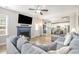Inviting living room with a blue fireplace, large TV, and open concept kitchen at 528 Holden Forest Dr, Youngsville, NC 27596