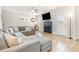 Cozy living room features a large sectional sofa, fireplace, and light wood-look flooring at 528 Holden Forest Dr, Youngsville, NC 27596