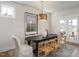 Dining room featuring an oval table with unique wooden chairs, stylish lighting, and glass doors to an outdoor space at 536 Folk Song Way, Wendell, NC 27591