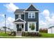 Charming two-story home with modern design, crisp white trim, lush lawn, and freshly landscaped yard at 536 Folk Song Way, Wendell, NC 27591