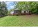 Lush green backyard with a stained wood deck and screened-in porch, perfect for outdoor enjoyment at 5604 Groomsbridge Ct, Raleigh, NC 27612