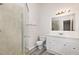 Bright bathroom features tile flooring, shower with glass door, and a single sink vanity at 5604 Groomsbridge Ct, Raleigh, NC 27612