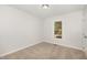 Neutral bedroom with carpet, a ceiling light, and window letting in natural sunlight at 5604 Groomsbridge Ct, Raleigh, NC 27612