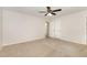 Bright bedroom features neutral carpet, white walls, a ceiling fan, and a double door closet at 5604 Groomsbridge Ct, Raleigh, NC 27612