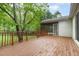 View of a stained wood deck with railing and screened-in porch, backing to mature trees at 5604 Groomsbridge Ct, Raleigh, NC 27612