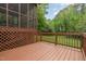 Spacious brown deck with lattice and wood railing overlooking a lush green backyard at 5604 Groomsbridge Ct, Raleigh, NC 27612