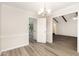 View of dining room featuring hard wood floors, white trim and decorative lighting at 5604 Groomsbridge Ct, Raleigh, NC 27612